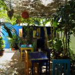 colorful Mexican backyard with flowers and tables